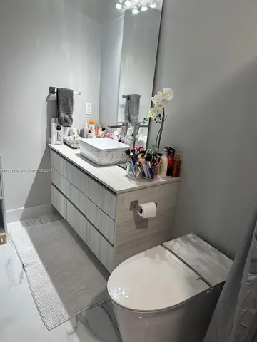 a bathroom with a sink mirror and vanity