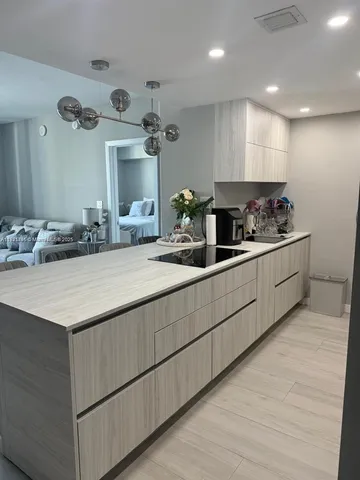 a kitchen with kitchen island a sink stainless steel appliances and cabinets