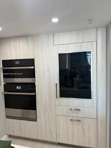 a view of kitchen with a microwave and cabinets