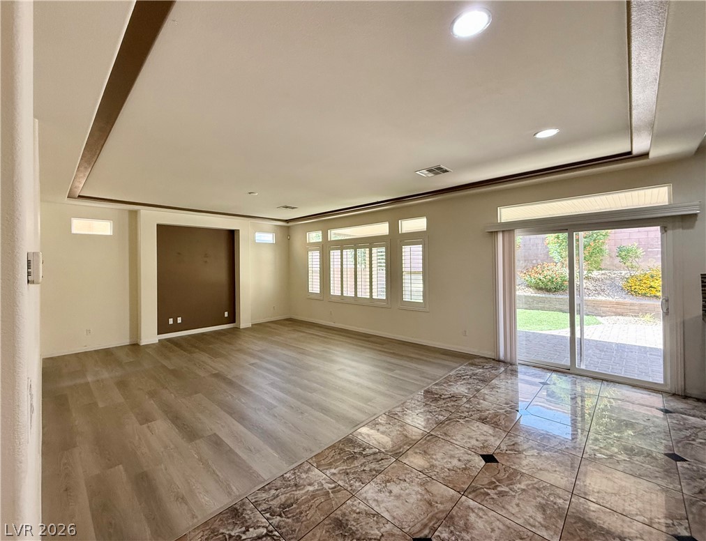 6459 Parrot Ridge Court Las Vegas, NV 89139 - Photo 7 of 23 A spacious living area with varied flooring and direct patio access offers versatile design potential.