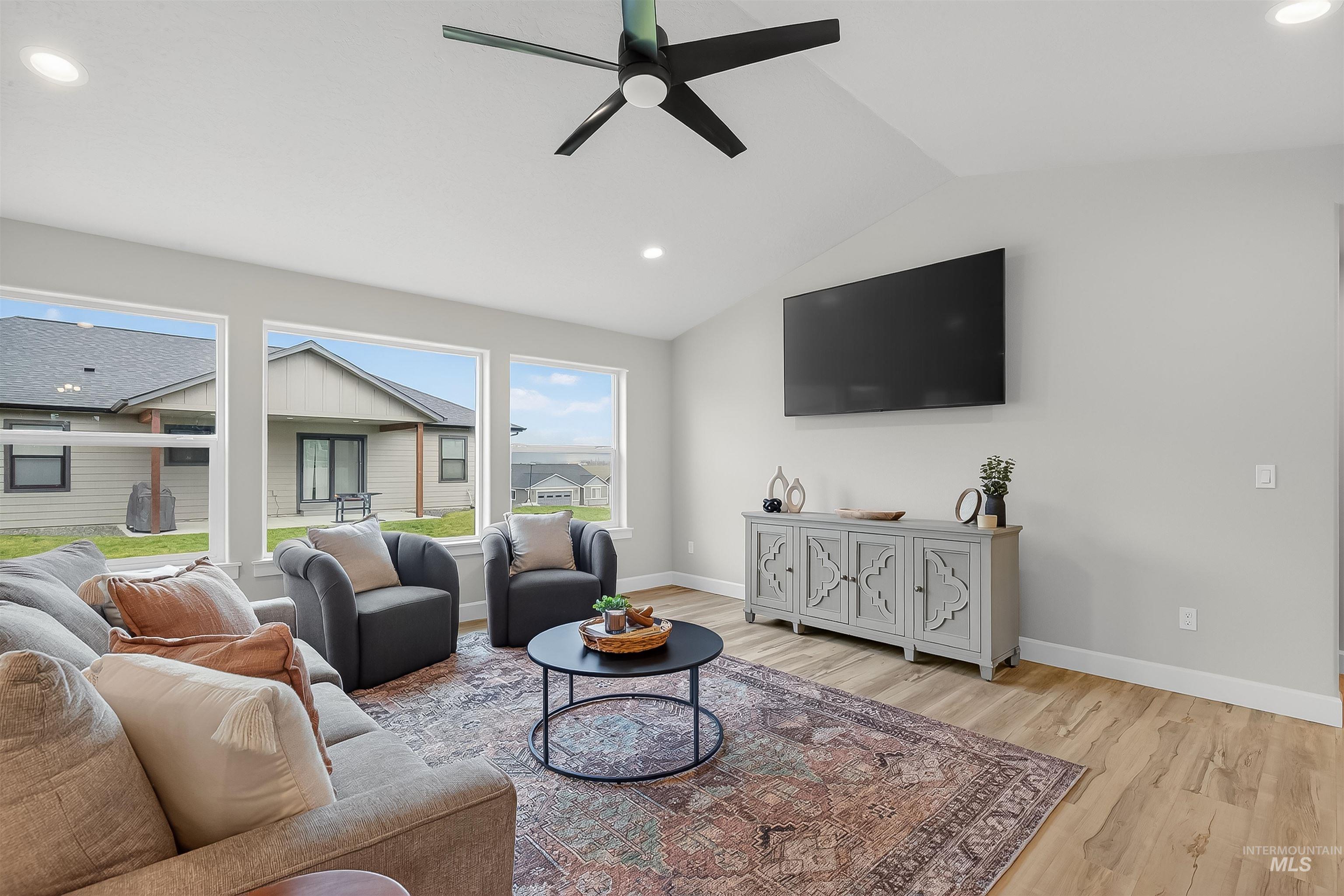 1725 Pathway Court Lewiston, ID 83501 - Photo 15 of 37 Living area featuring vaulted ceiling, light wood finished floors, recessed lighting, and a ceiling fan