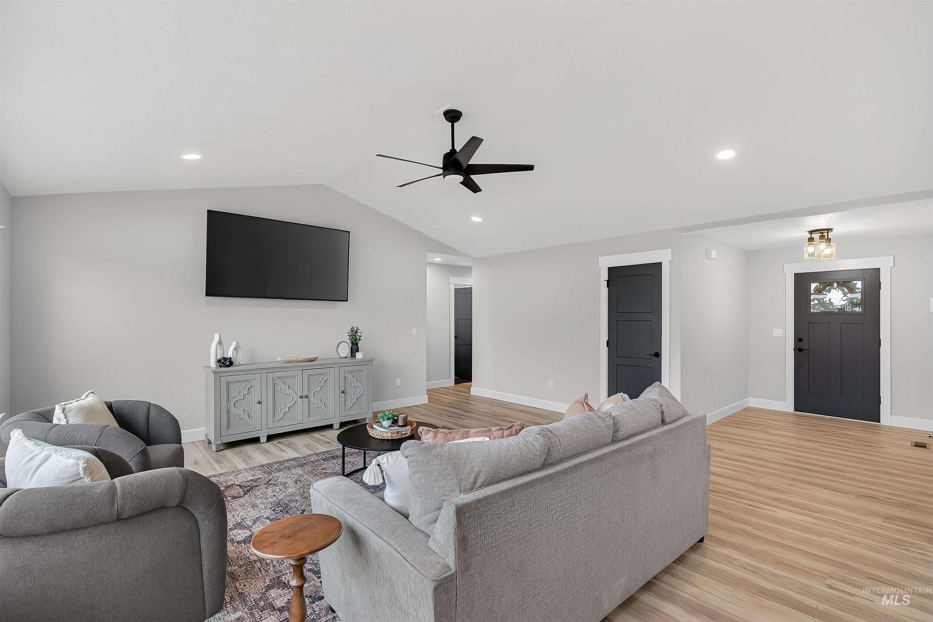 1725 Pathway Court Lewiston, ID 83501 - Photo 16 of 37 Living room featuring ceiling fan, light wood-style floors, lofted ceiling, and recessed lighting