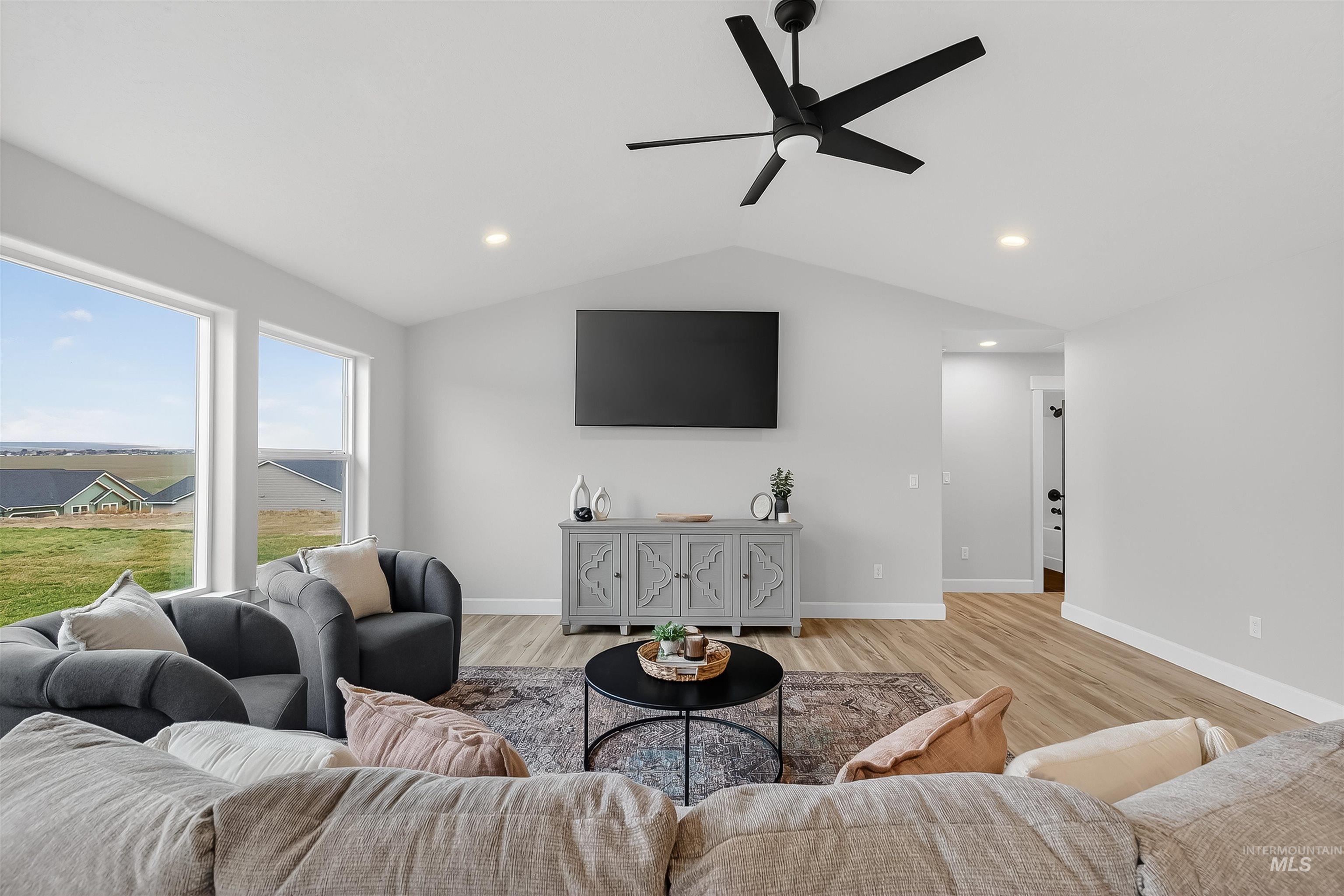 1725 Pathway Court Lewiston, ID 83501 - Photo 17 of 37 Living area featuring lofted ceiling, ceiling fan, light wood-type flooring, and recessed lighting