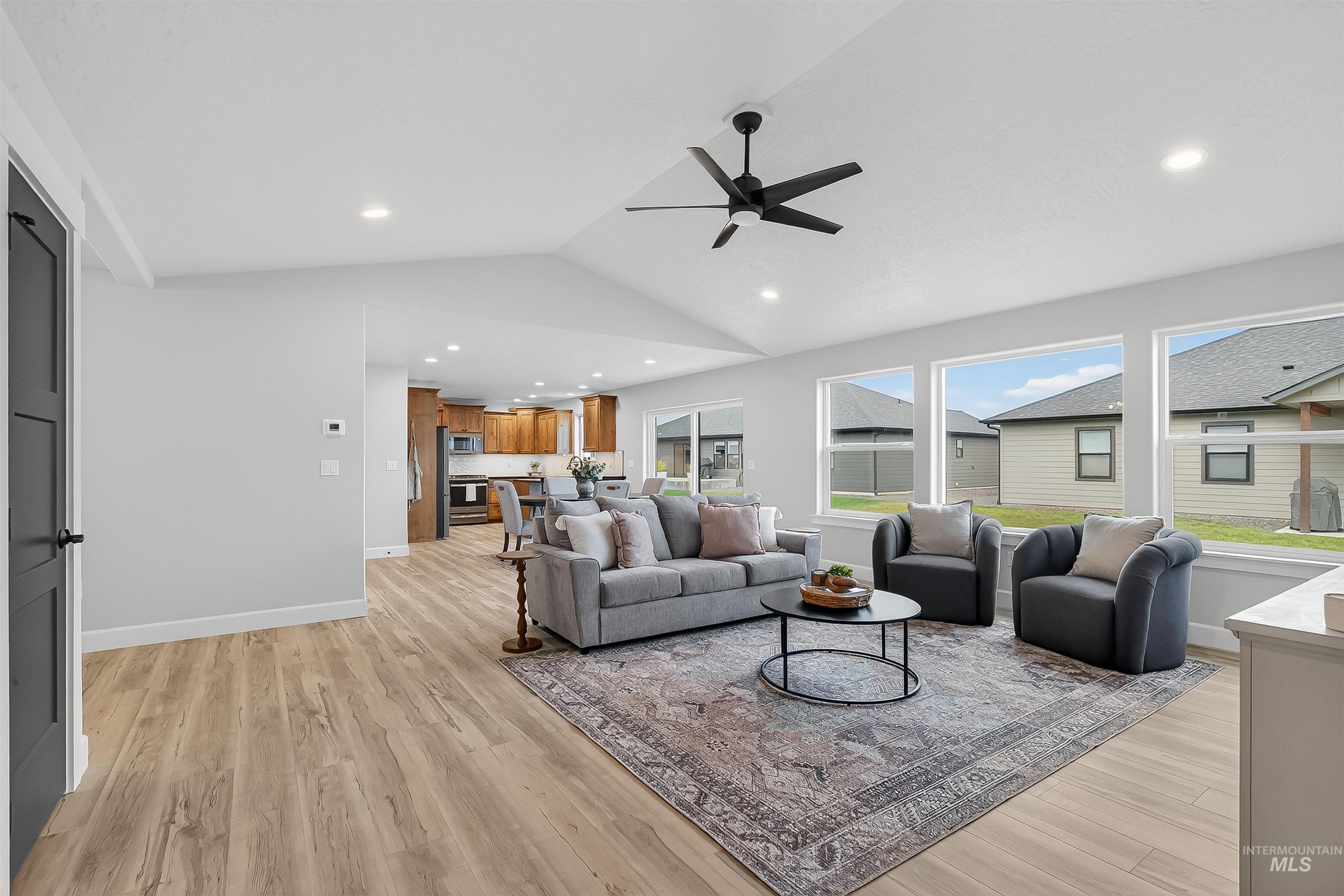 1725 Pathway Court Lewiston, ID 83501 - Photo 18 of 37 Living room with lofted ceiling, light wood-type flooring, ceiling fan, and recessed lighting