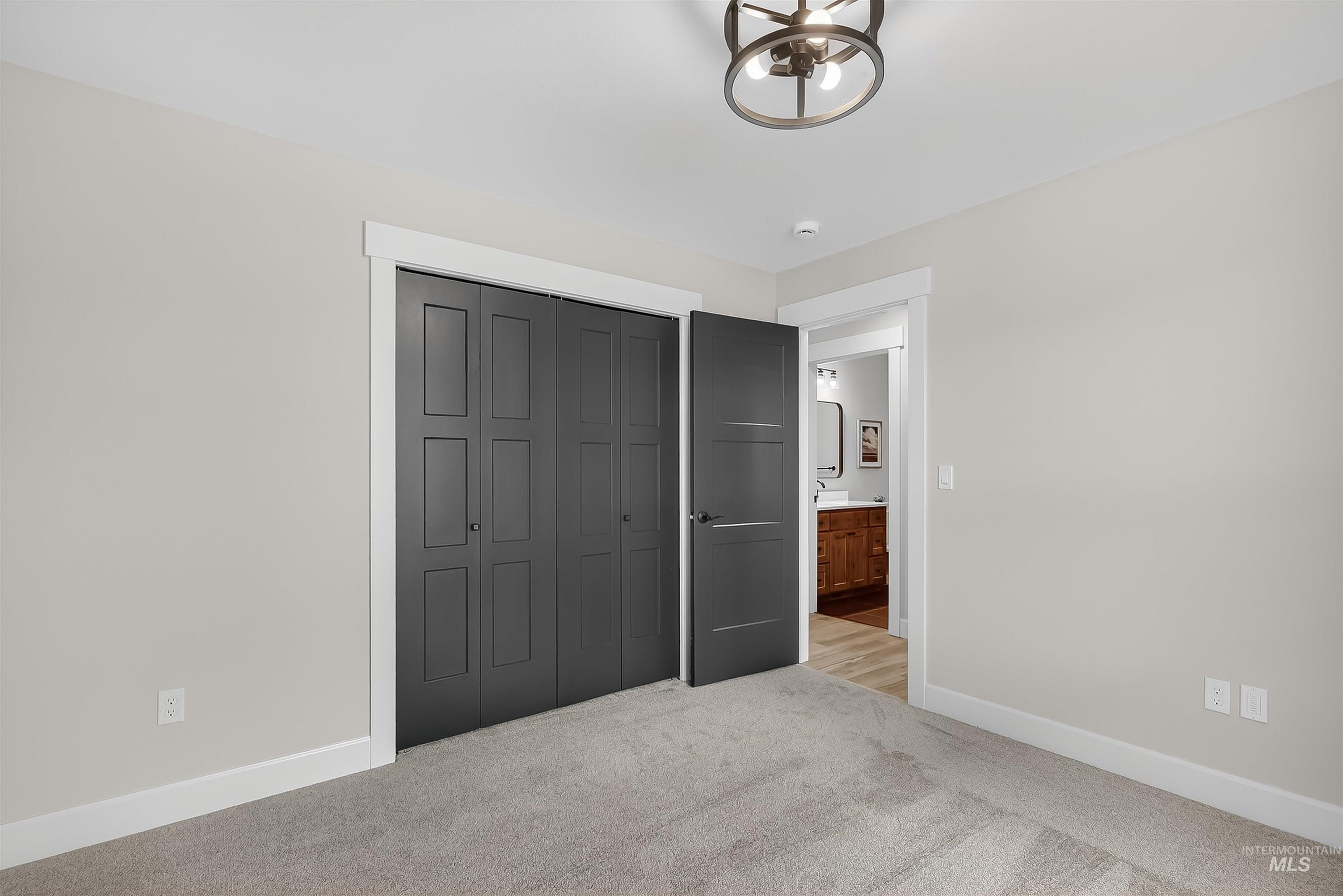 1725 Pathway Court Lewiston, ID 83501 - Photo 25 of 37 Unfurnished bedroom with carpet floors, a closet, and a chandelier