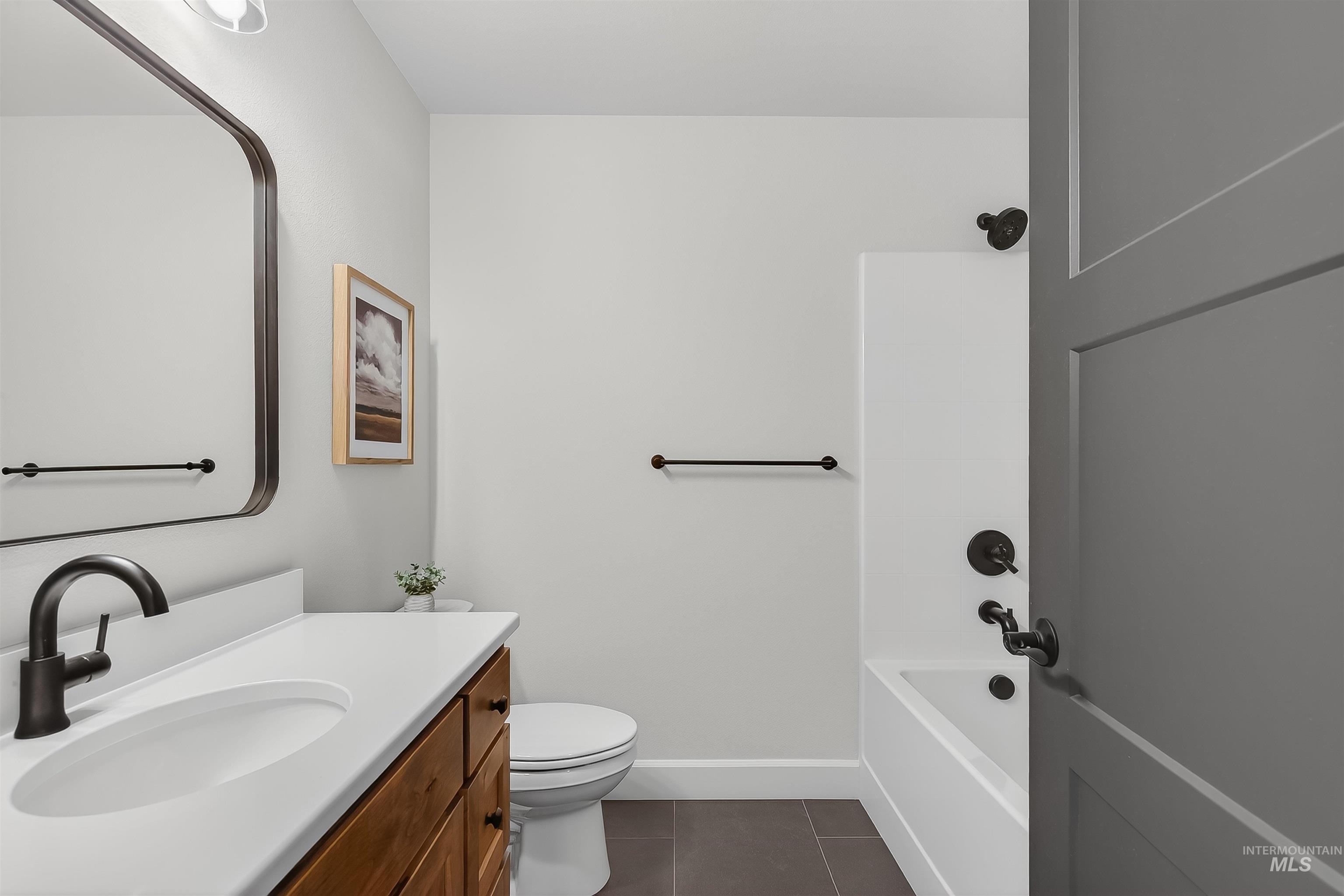 1725 Pathway Court Lewiston, ID 83501 - Photo 26 of 37 Full bathroom featuring vanity, dark tile patterned floors, and shower / bath combination