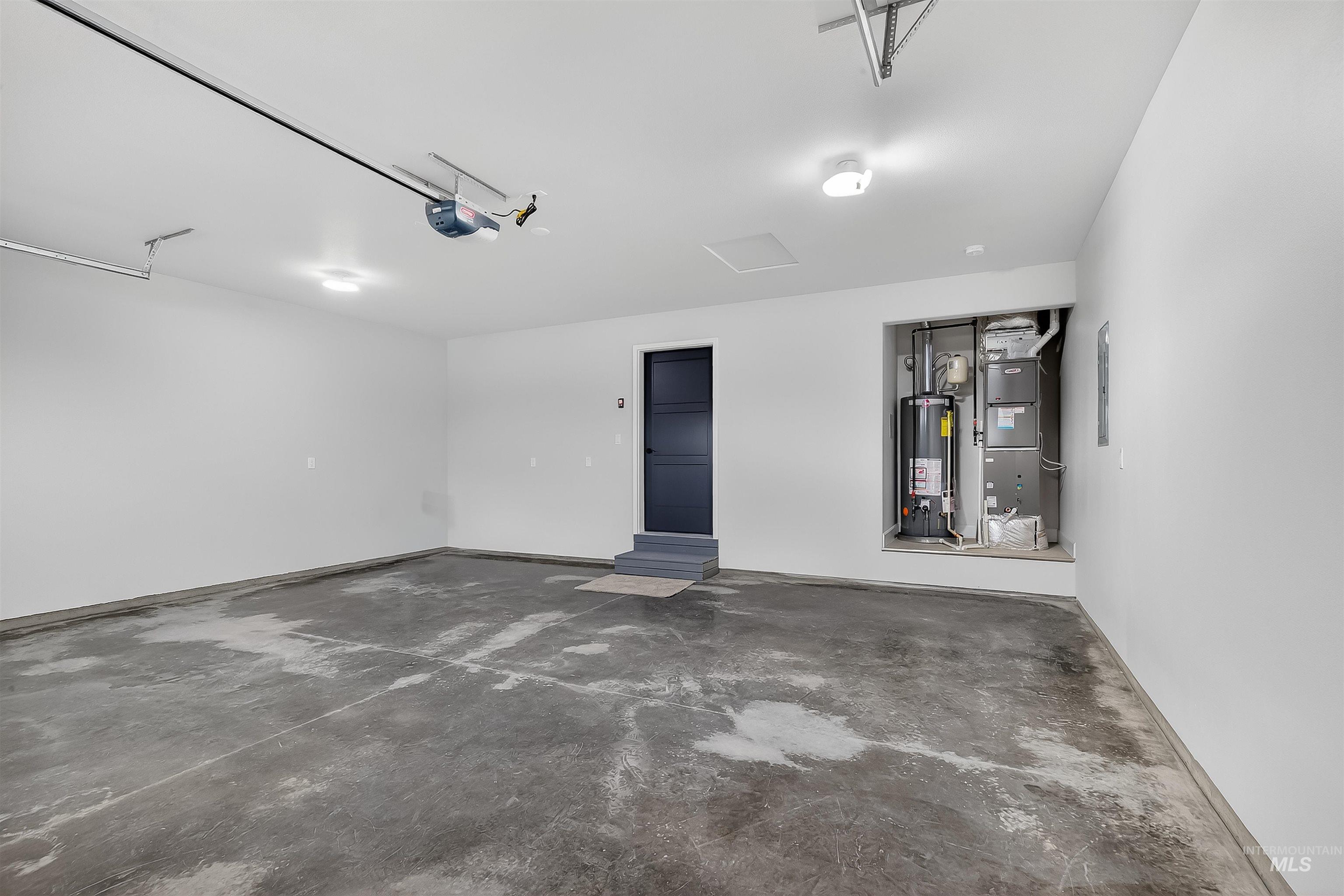1725 Pathway Court Lewiston, ID 83501 - Photo 31 of 37 Garage with heating unit, water heater, electric panel, and a garage door opener