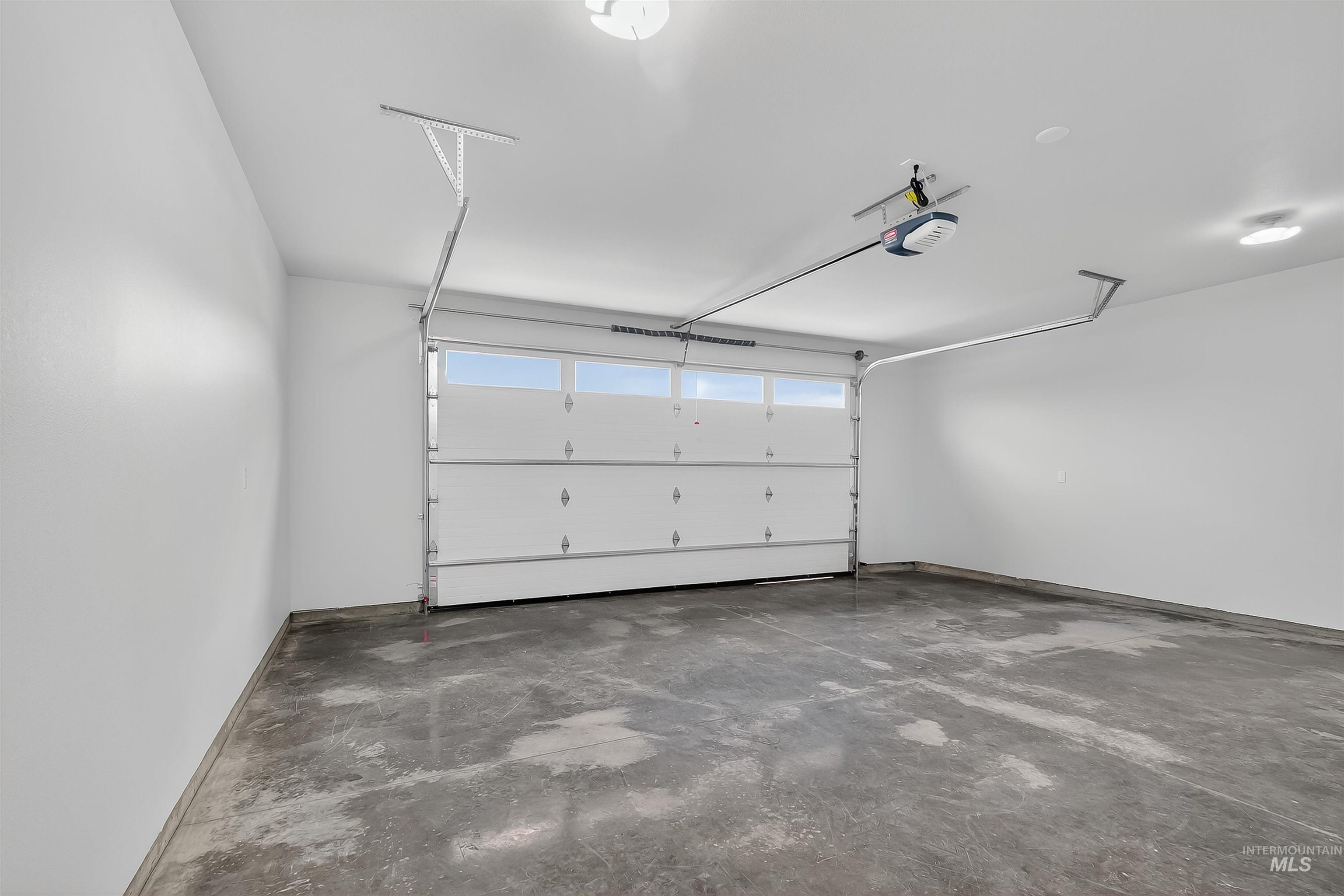 1725 Pathway Court Lewiston, ID 83501 - Photo 32 of 37 Garage featuring baseboards and a garage door opener