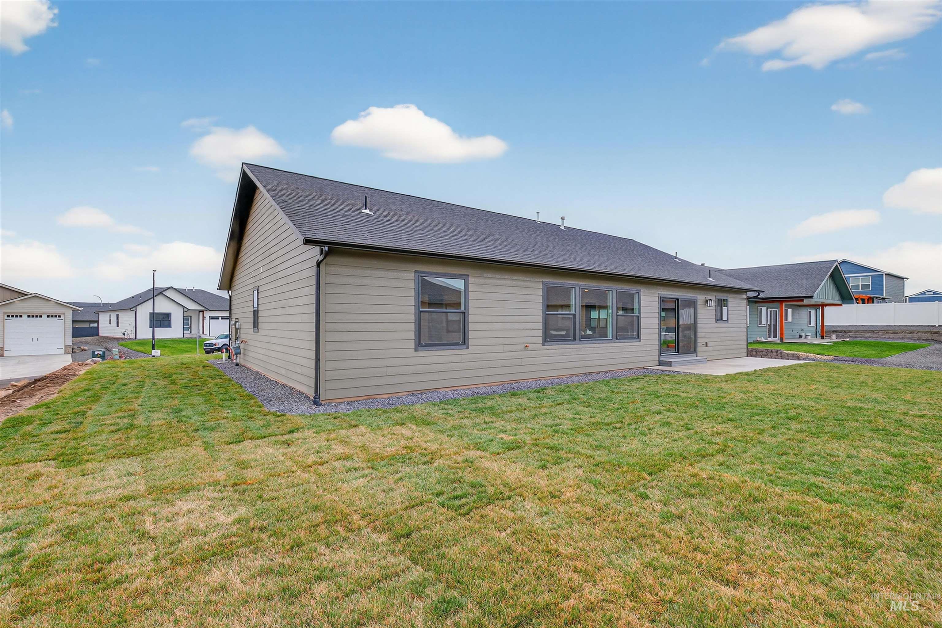 1725 Pathway Court Lewiston, ID 83501 - Photo 33 of 37 Rear view of property featuring a yard, a patio area, and roof with shingles