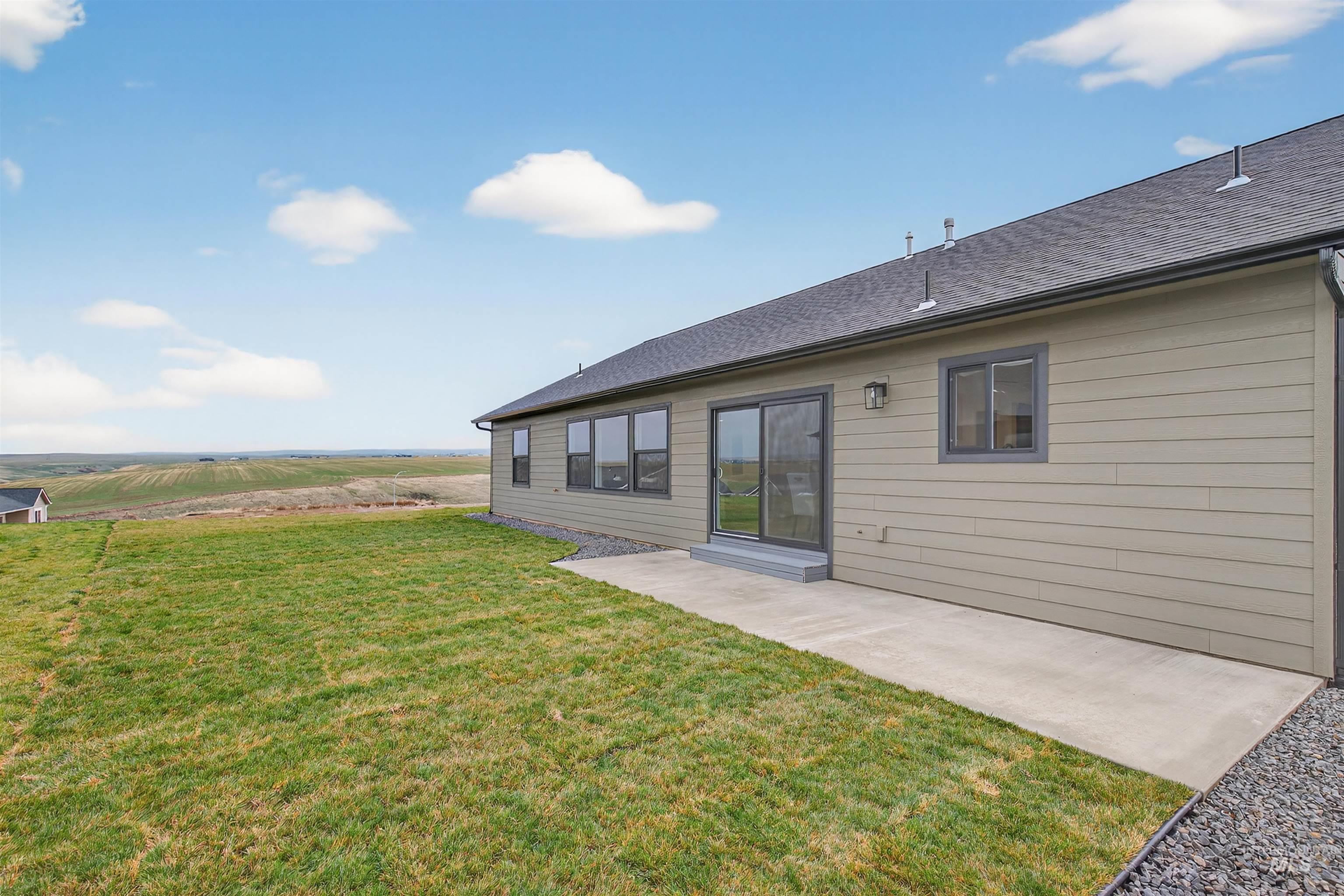 1725 Pathway Court Lewiston, ID 83501 - Photo 34 of 37 Rear view of property with a patio, a yard, and roof with shingles