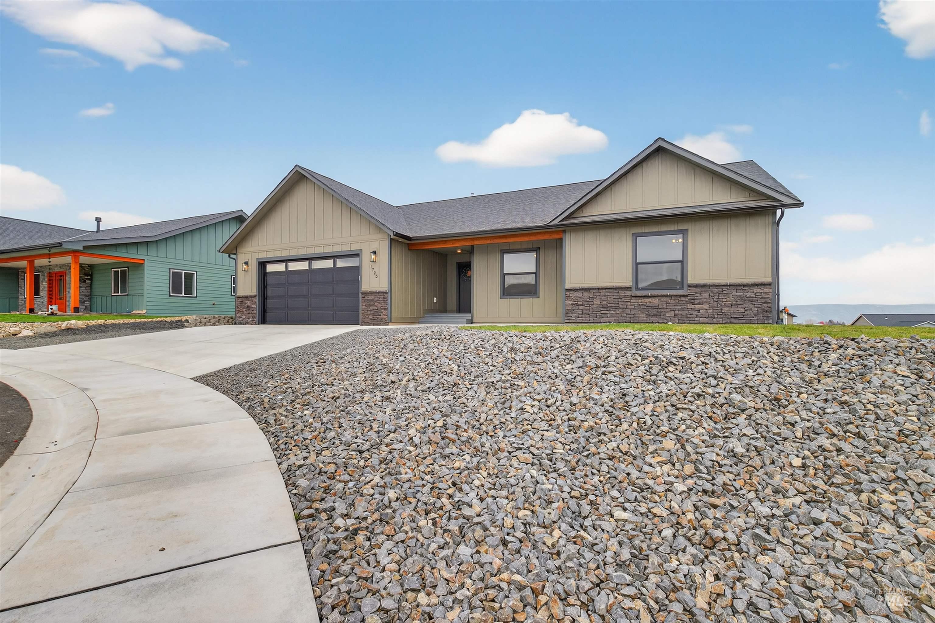 1725 Pathway Court Lewiston, ID 83501 - Photo 37 of 37 View of front of house featuring stone siding, concrete driveway, board and batten siding, and a garage