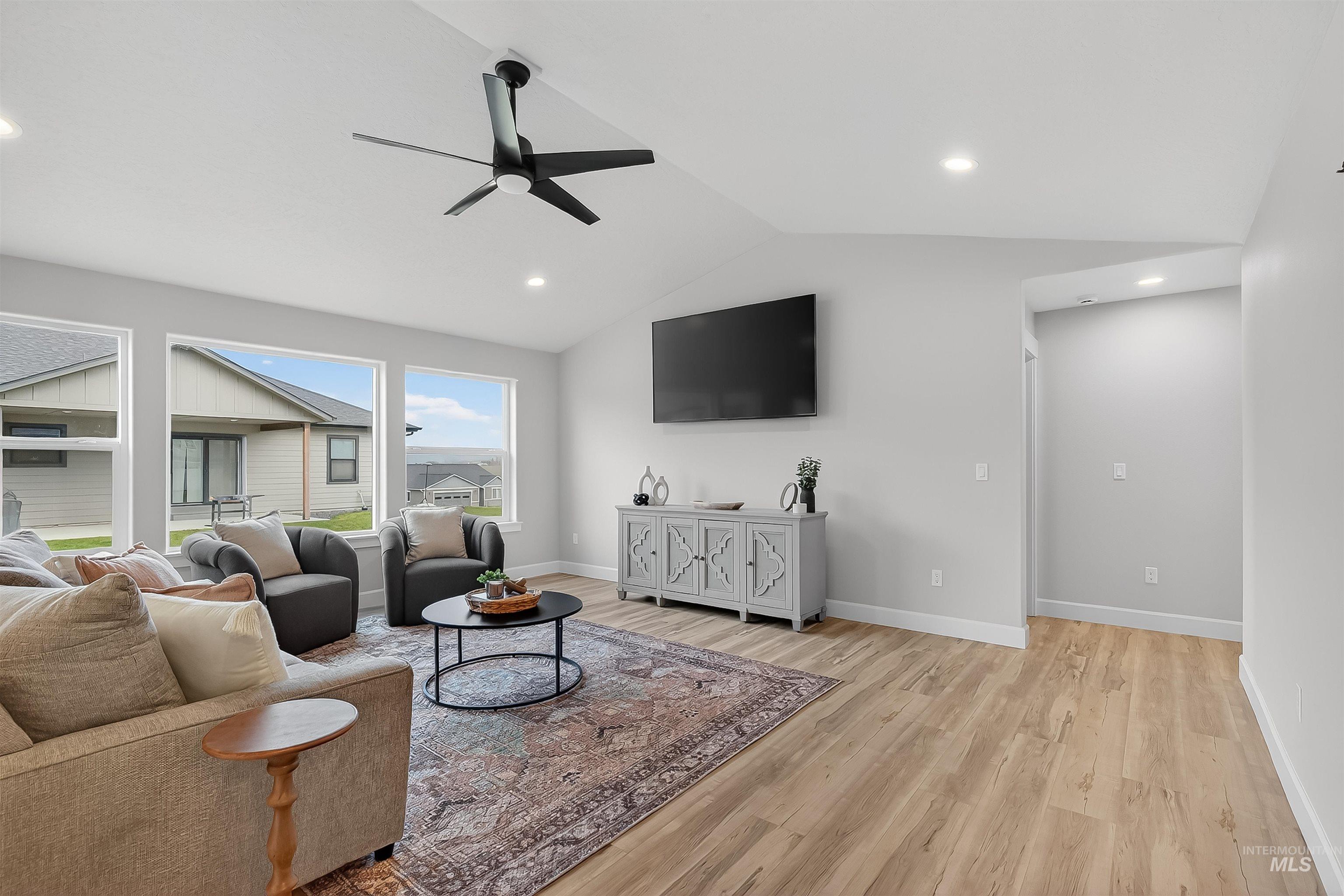 1725 Pathway Court Lewiston, ID 83501 - Photo 4 of 37 Living area with vaulted ceiling, light wood-type flooring, ceiling fan, and recessed lighting