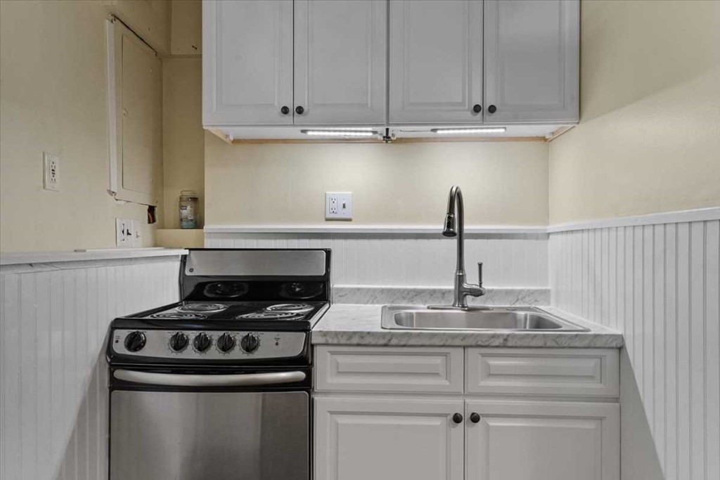 170 Shepard Road Sturbridge, MA 01566 - Photo 30 of 41 a kitchen with granite countertop white cabinets and a stove