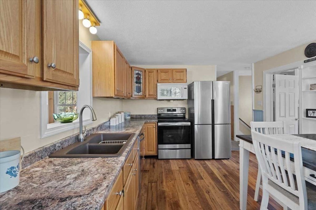170 Shepard Road Sturbridge, MA 01566 - Photo 6 of 41 a kitchen with granite countertop a sink a counter space appliances and cabinets