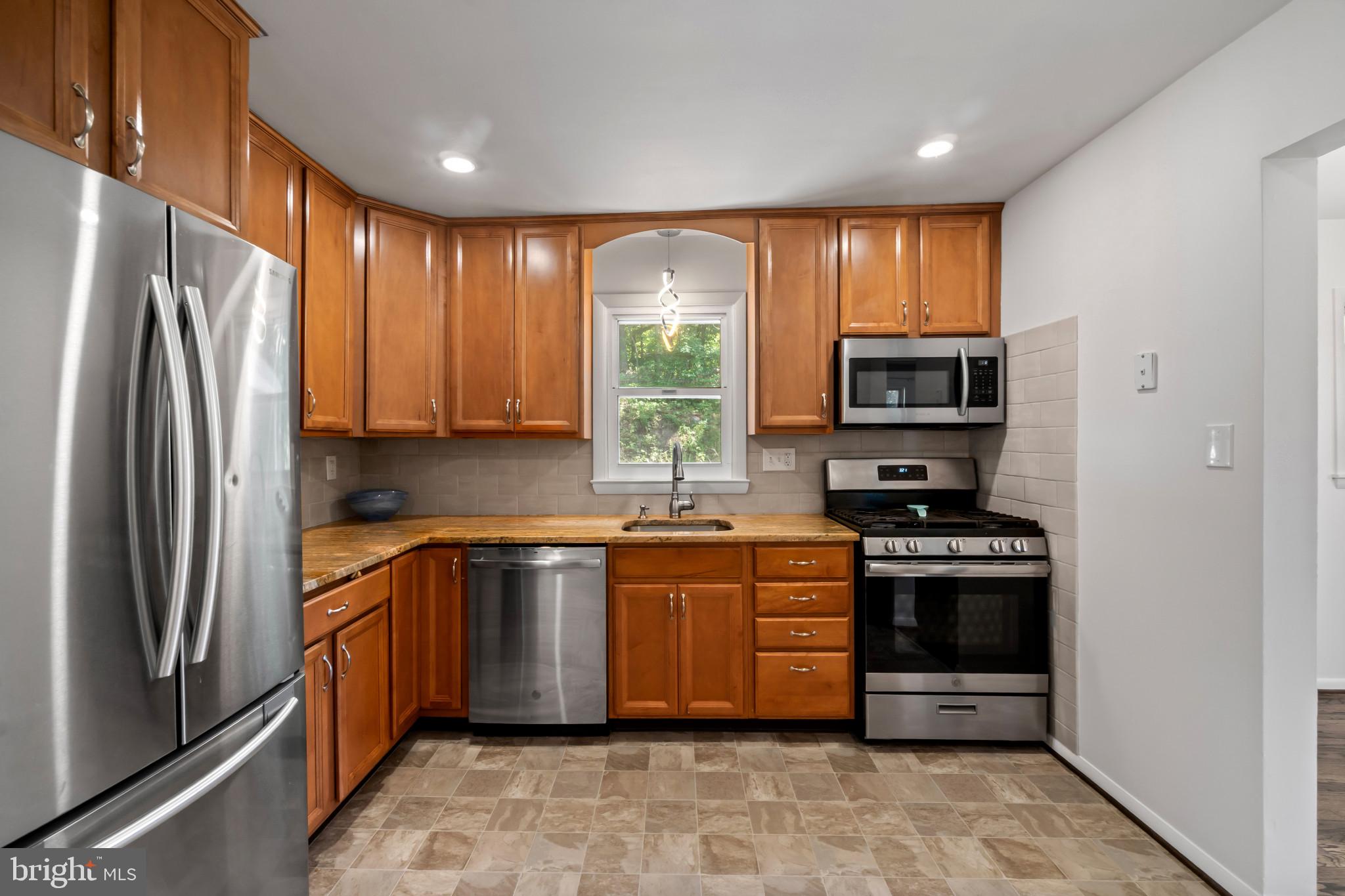 415 Baylor Road Glen Burnie, MD 21061 - Photo 8 of 29 a large kitchen with stainless steel appliances granite countertop a refrigerator stove and sink