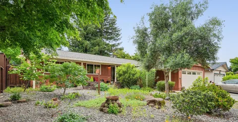 a view of backyard of house with green space