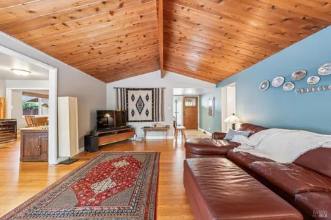 a living room with furniture a rug and a bookshelf