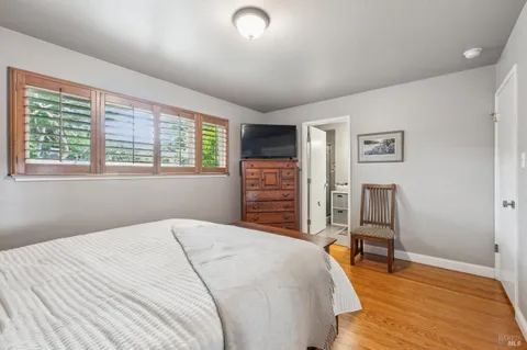 a bedroom with a bed and a chair
