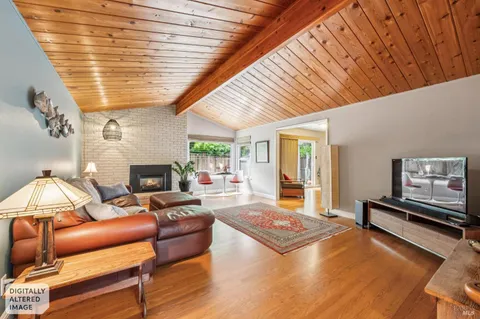 a living room with furniture a rug and a large window