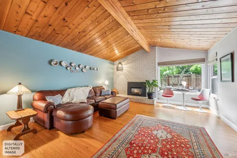 a living room with furniture flat screen tv and a table