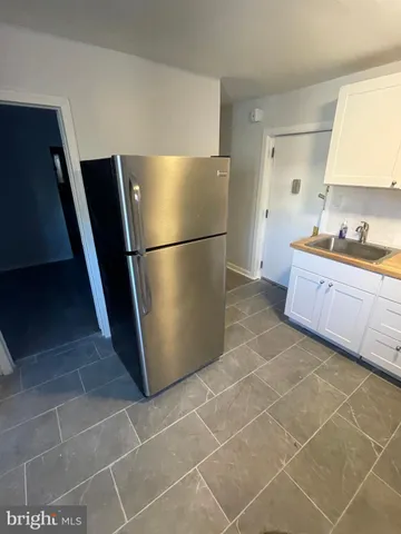 a kitchen with a sink a refrigerator and a stove