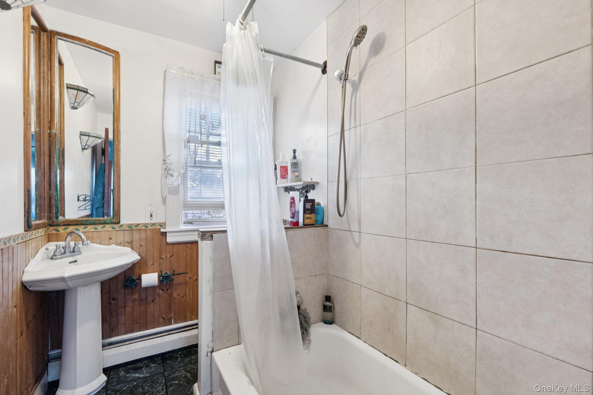 83 Elm Road East Mastic Beach, NY 11951 - Photo 11 of 34 a bathroom with a sink and a mirror