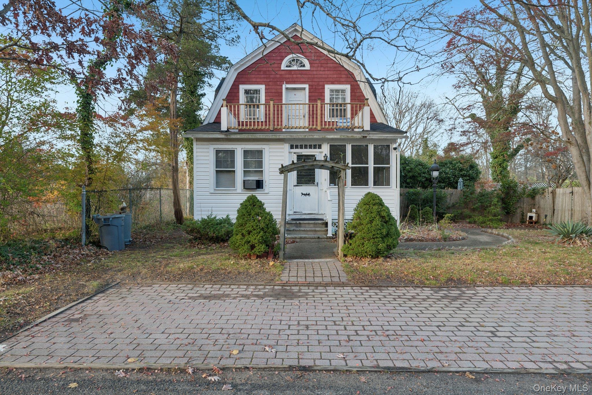 83 Elm Road East Mastic Beach, NY 11951 - Photo 2 of 34 a front view of a house with garden