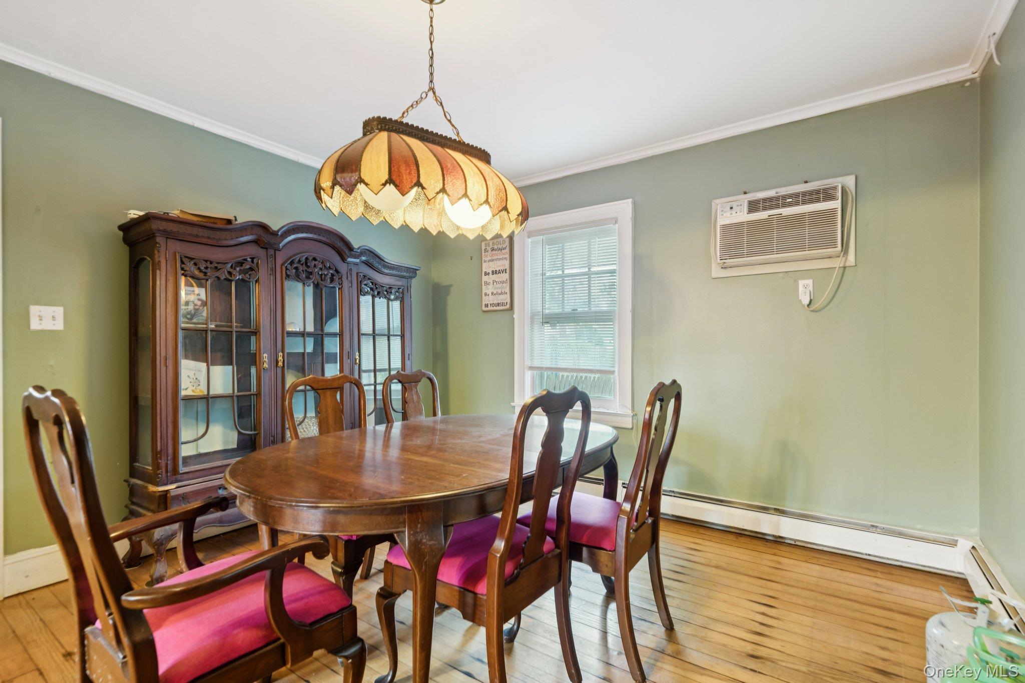 83 Elm Road East Mastic Beach, NY 11951 - Photo 5 of 34 a dining room with furniture a rug and wooden floor