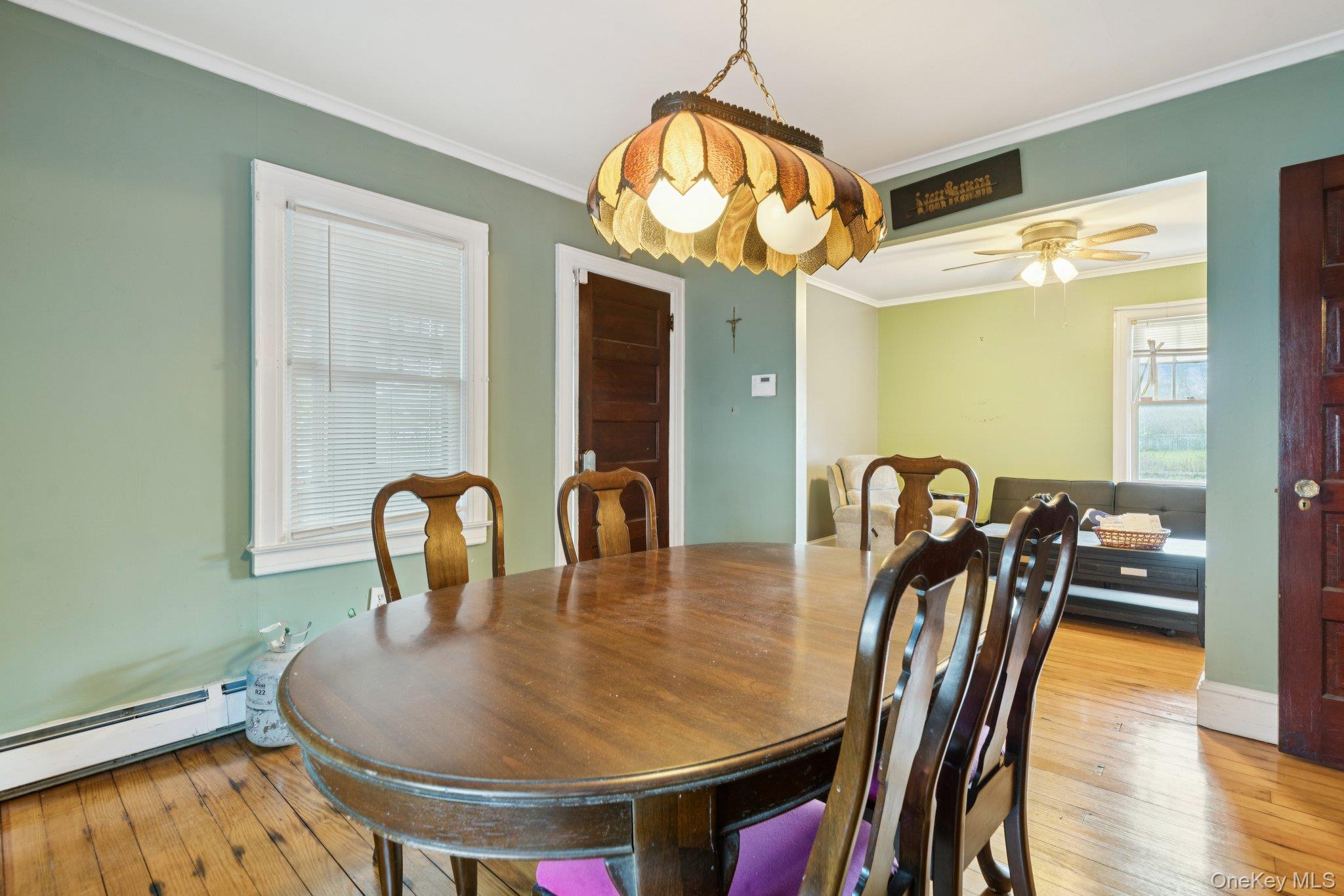 83 Elm Road East Mastic Beach, NY 11951 - Photo 6 of 34 a view of a dining room with furniture and wooden floor