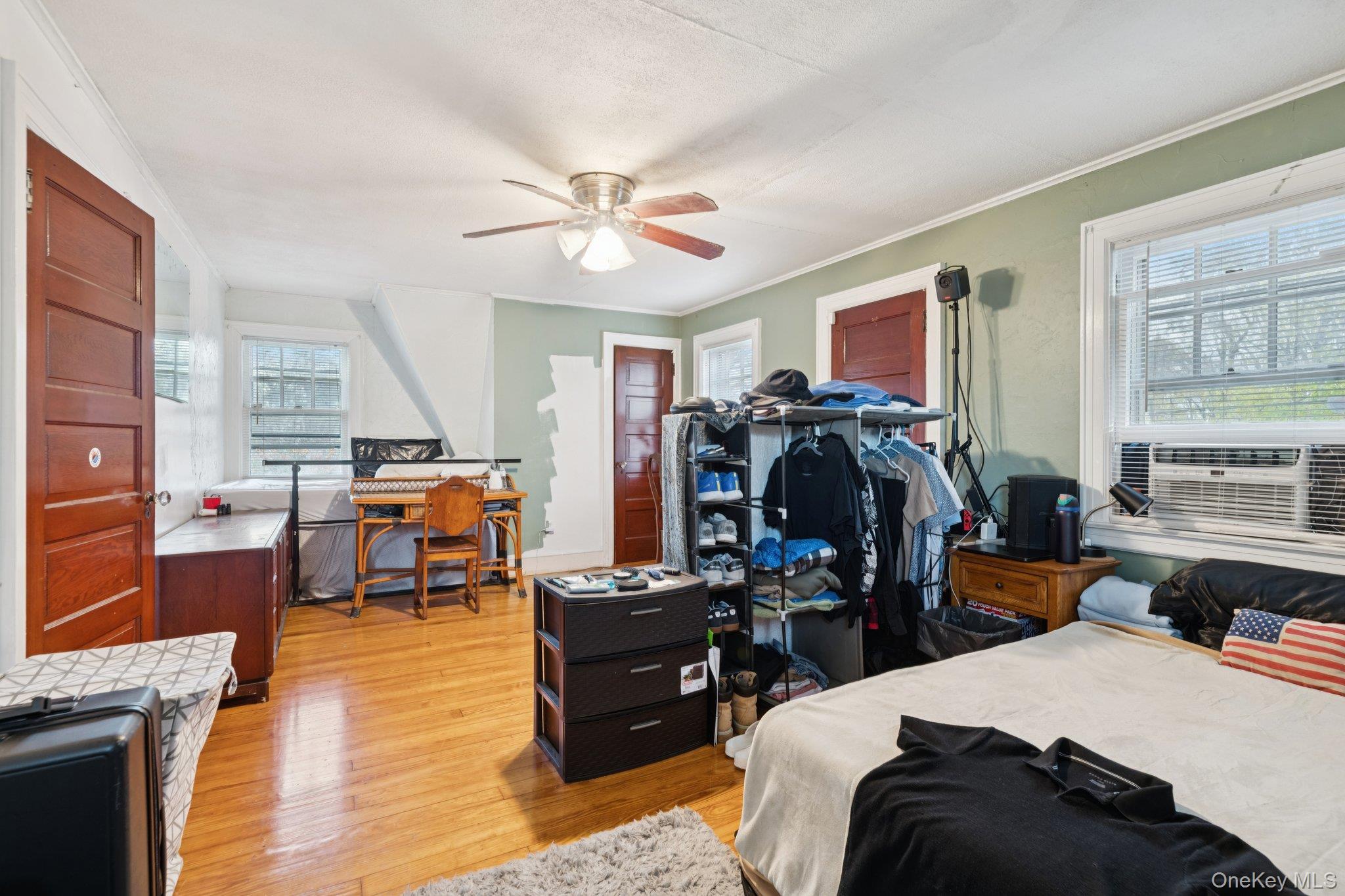 83 Elm Road East Mastic Beach, NY 11951 - Photo 10 of 34 a living room with furniture and a chandelier