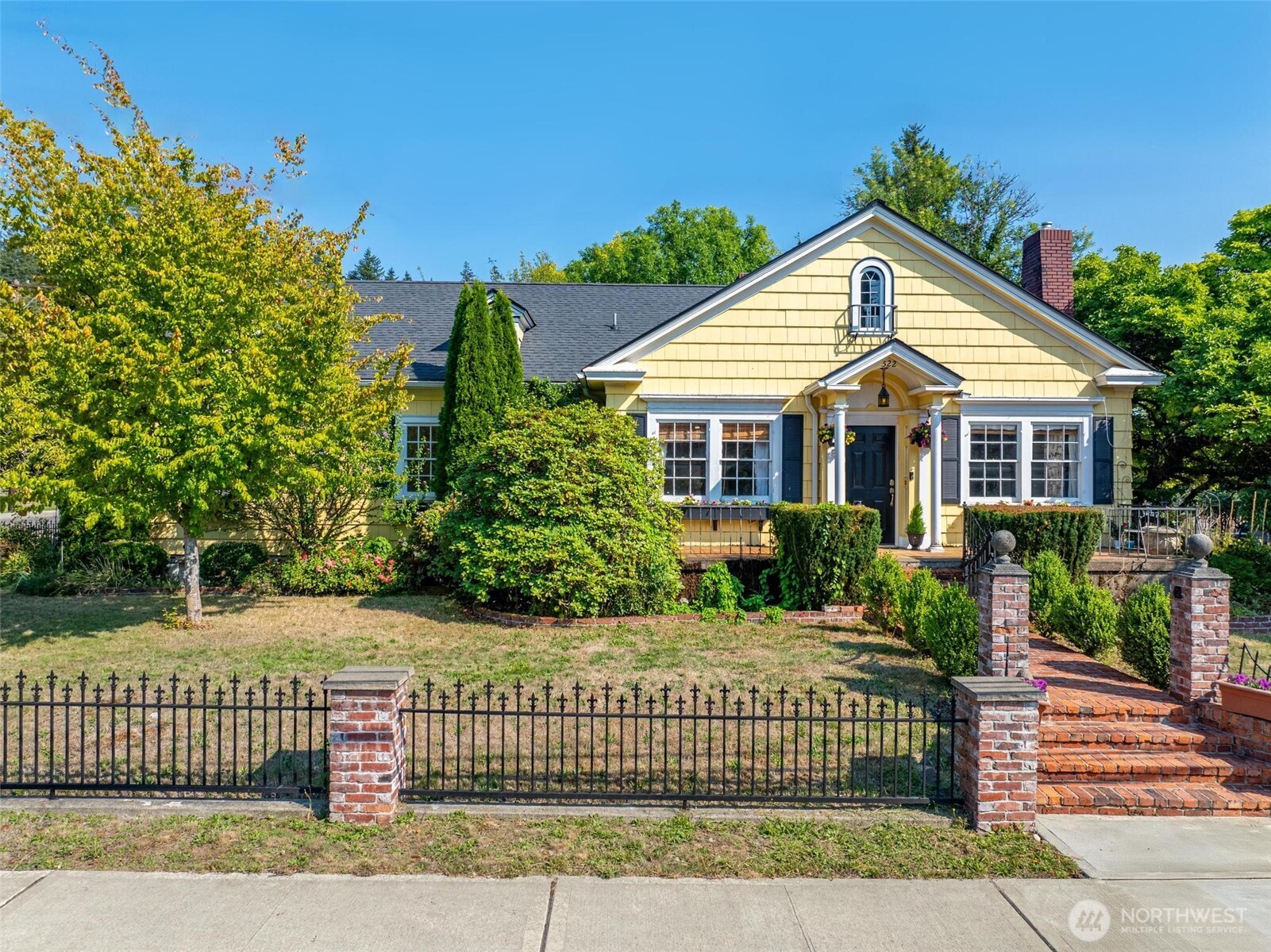 a front view of a house with a garden