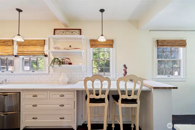 a view of a kitchen with a table and chairs