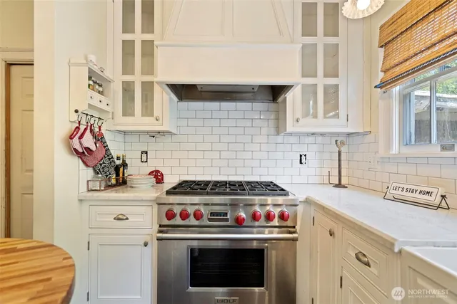 a kitchen with stainless steel appliances a stove and cabinets