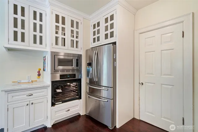 a kitchen with cabinets and stainless steel appliances