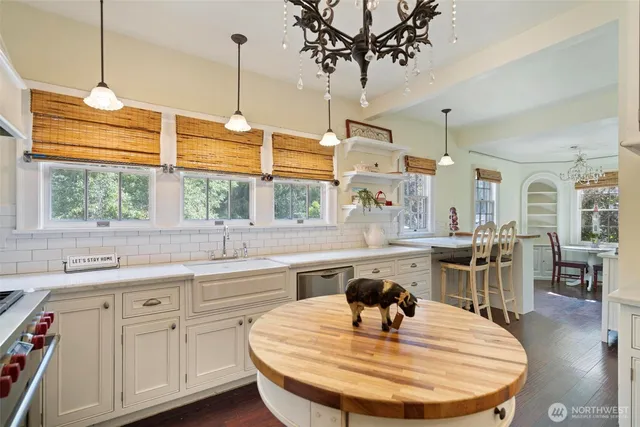 a kitchen with center island table and chairs