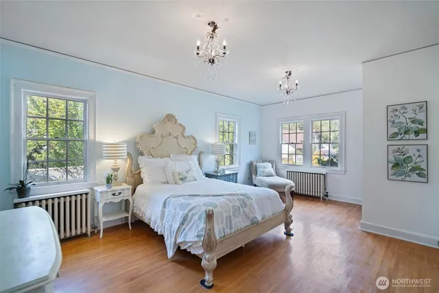 a bedroom with a bed and a large window