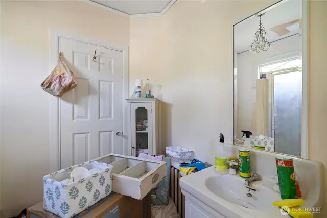 a bath room with a table chairs and a chandelier
