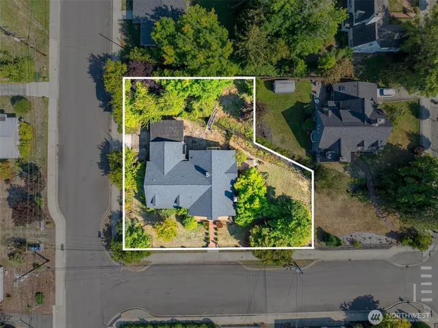 an aerial view of a house with a yard and a garage