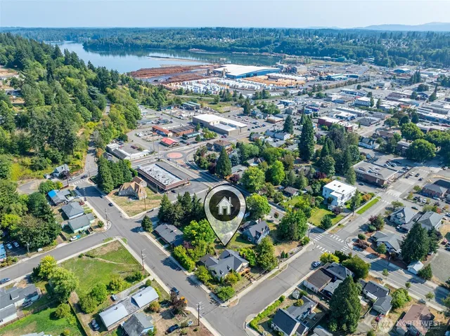 an aerial view of a residential houses with outdoor space and street view