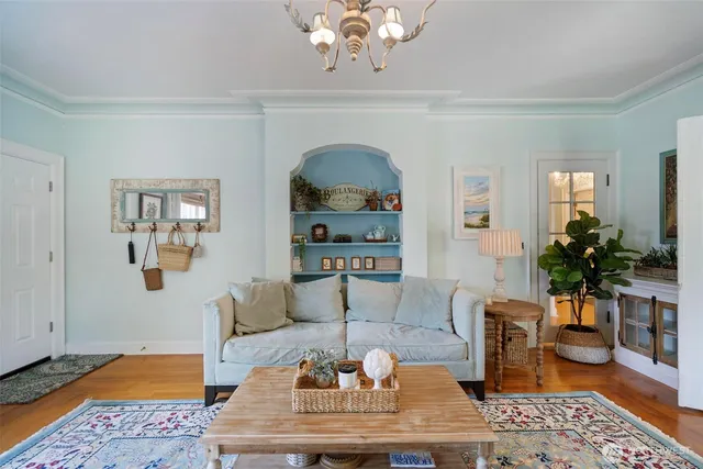 a living room with furniture a rug and a window
