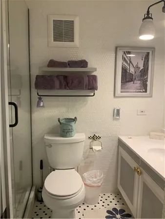 a bathroom with a toilet a sink and mirror