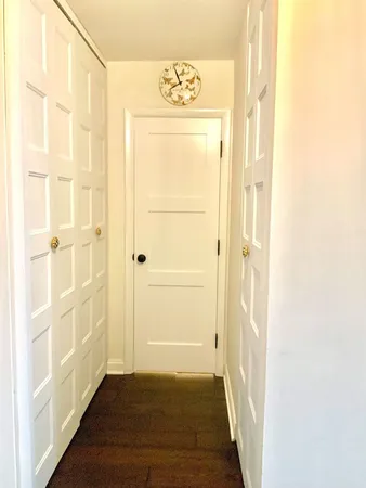 a view of a bathroom with wooden floor and a window