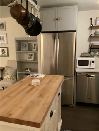 a kitchen with stainless steel appliances granite countertop a sink a stove and a refrigerator