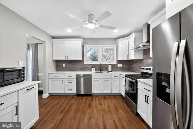 a utility room with cabinets washer and dryer