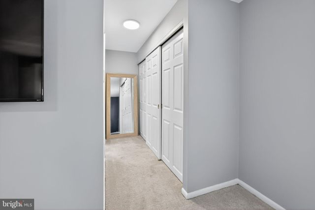 a bathroom with a granite countertop toilet a sink a shower and mirror