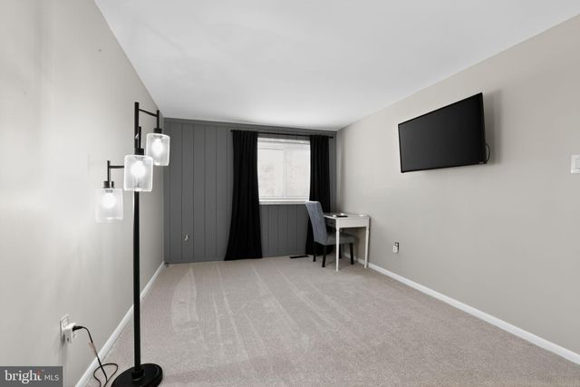 a view of a livingroom with wooden floor and a flat screen tv
