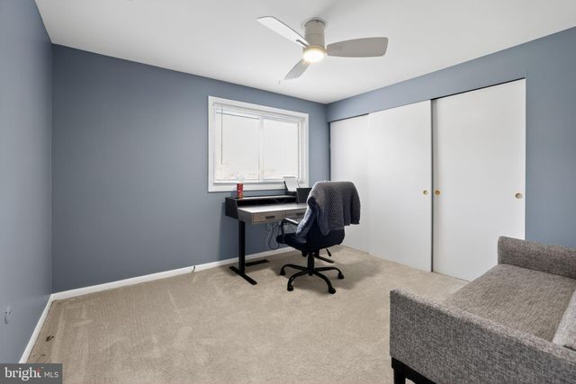 a bedroom with furniture and a chair