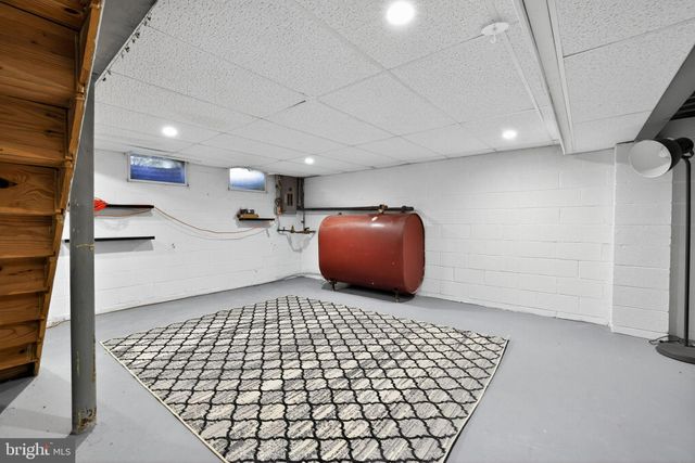 a front view of a house with a garden and yard