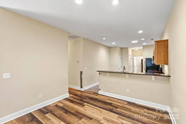 a view of kitchen with stainless steel appliances cabinets