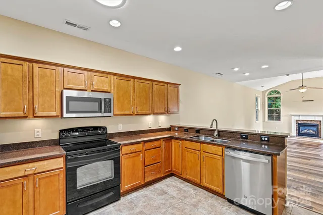 a kitchen with a sink stove and microwave